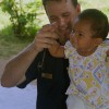 428px-US_Navy_070620-N-0120A-091_Dock_landing_ship_USS_Harpers_Ferry_(LSD_49)_medical_doctor_Lt._Terrence_M._Kilfoil_plays_with_a_Thai_toddler_after_a_check-up_during_a_medical_civil_act